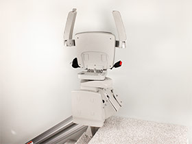 Bruno Elan stairlift folded up at top of stairs
