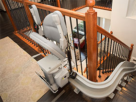 Bruno Elite curved stairlift wrapped around a top landing