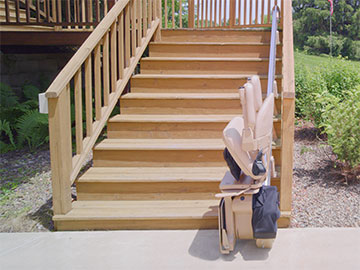 Bruno Elite outdoor stairlift parked at bottom of deck stairs